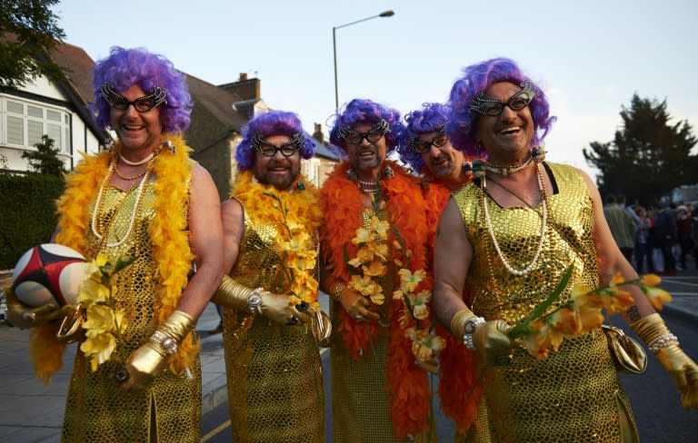 Australian fans dressed as Dame Edna Everage, the character portrayed by Australian comedian Barry Humphries, pose for a photo ahead of the Rugby World Cup Pool A match England vs Australia, in London, on October 3, 2015