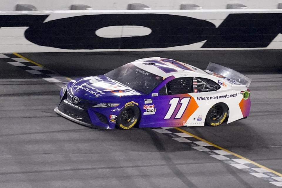 Denny Hamlin wins the first stage during the NASCAR Daytona 500 auto race at Daytona International Speedway, Sunday, Feb. 14, 2021, in Daytona Beach, Fla. (AP Photo/John Raoux)