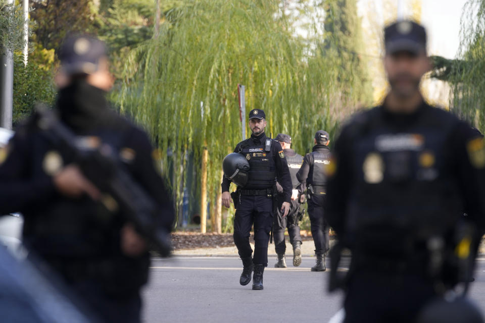 Police officers stand guard as they cordon off the area next to the Ukrainian embassy in Madrid, Spain, Wednesday, Nov. 30, 2022. Spain's Interior Ministry says police are investigating reports of a blast at the Ukrainian embassy in Madrid. The ministry says police were told an employee at the embassy was slightly injured handling a letter in what it described as "a deflagration." (AP Photo/Paul White)