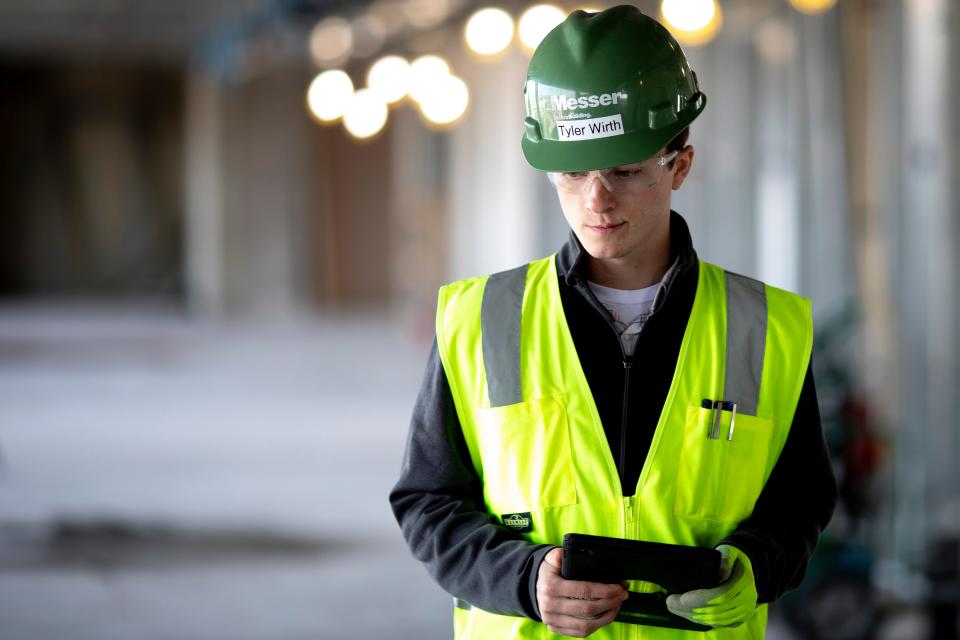 Tyler Wirth, a University of Cincinnati sophomore who works as a project engineer for Messer Construction through the UC cooperative program, makes a safety inspection of a Messer construction site on the UC campus on Tuesday, Nov. 16, 2021. Wirth is in his second cooperative work semester at UC.