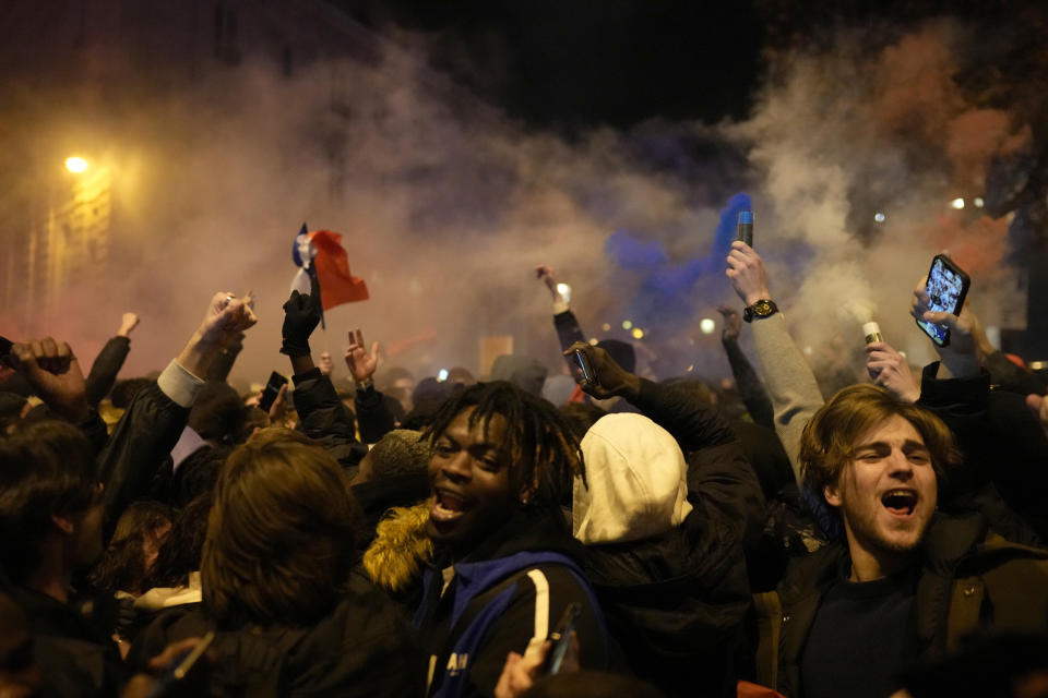 Supporters of France react next to the Arc de Triomphe on the Champs Elysees avenue at the end of the World Cup semifinal soccer match between France and Morocco, in Paris, Wednesday, Dec. 14, 2022. (AP Photo/Thibault Camus)