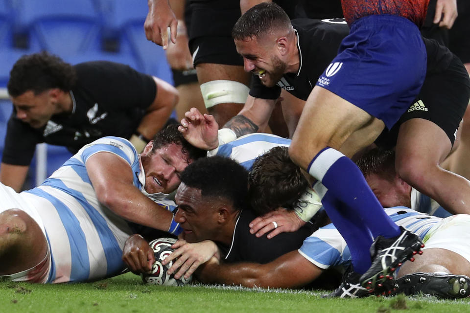 New Zealand's Sevu Reece, center, scores a try against Argentina during their Rugby Championship match on Sunday, Sept. 12, 2021, on the Gold Coast, Australia. (AP Photo/Tertius Pickard)