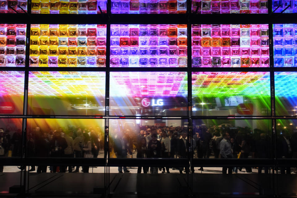 People look at an exhibit of LG Signature OLED T 4K transparent wireless TV's at the LG booth during the CES tech show Tuesday, Jan. 9, 2024, in Las Vegas. (AP Photo/John Locher)