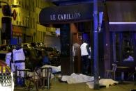 A general view of the scene that shows the covered bodies outside a restaurant following a shooting incident in Paris, France, November 13, 2015. REUTERS/Philippe Wojazer