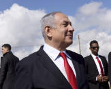 Israeli Prime Minister Benjamin Netanyahu, center, surrounded by bodyguards, gets an overview of the West Bank Israeli settlement of Har Homa where he announced a new neighborhood is to be built, Thursday, Feb. 20, 2020. (Debbie Hill/Pool via AP)
