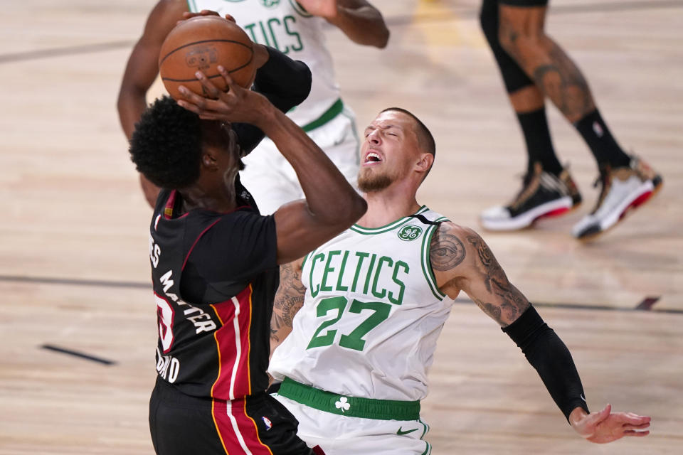 Miami Heat's Bam Adebayo, left, goes up for a shot as Boston Celtics' Daniel Theis (27) defends during the first half of an NBA conference final playoff basketball game Sunday, Sept. 27, 2020, in Lake Buena Vista, Fla. (AP Photo/Mark J. Terrill)