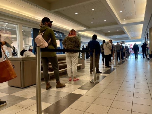People wait in line for a COVID-19 vaccine clinic at Southland Mall in Regina, Sask., on Sept. 17, 2021.  (Jessie Anton/CBC  - image credit)
