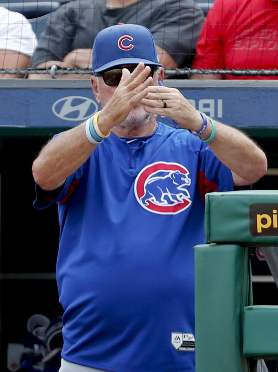 Chicago Cubs manager Joe Maddon call for a timeout with the bases loaded to pull the outfield in and have an outfielder change gloves as the Pittsburgh Pirates bat in the ninth inning of a baseball game Sunday, Aug. 19, 2018, in Pittsburgh. (AP Photo/Keith Srakocic)