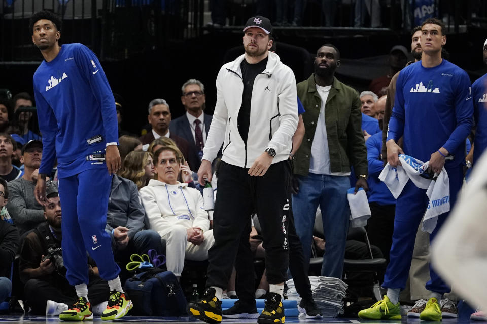 Dallas Mavericks guard Luka Doncic, center, begins to walk off the court with teammates at the end of the first half of an NBA basketball game against the San Antonio Spurs in Dallas, Sunday, April 9, 2023. (AP Photo/LM Otero)