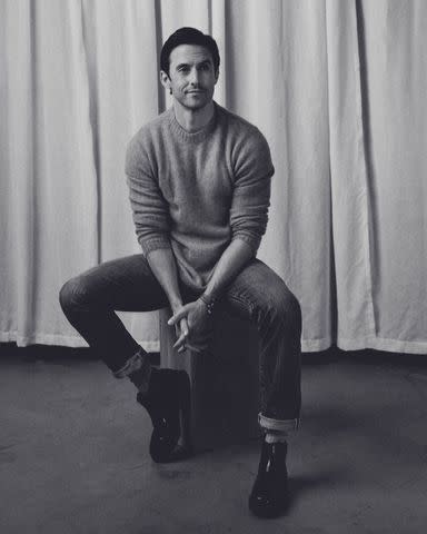 <p>Alex Harper</p> Irish Crone sweater. Todd Snyder jeans. Ralph Lauren belt. Kurt Geiger boot. London Sock Company socks. Rolex watch.