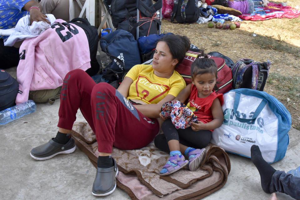 Migrants who are taking part in a caravan rest on the outskirts of Tapachula, Chiapas state, Mexico, Sunday, April 23, 2023. Migrants set out Sunday on what they call a mass protest procession through southern Mexico to demand the end of detention centers like the one that caught fire last month, killing 40 migrants. (AP Photo/Edgar H. Clemente)