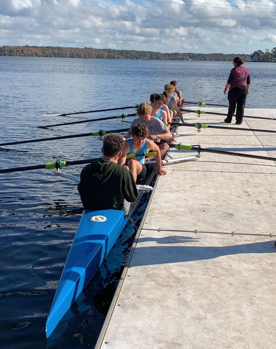 A rowing team gets ready, with the coxswain sitting in front leading the team, on South Watuppa Pond in Fall River, as part of the Massachusetts Public School Rowing Association’s Fall Championship Regatta on Oct. 31, 2021.