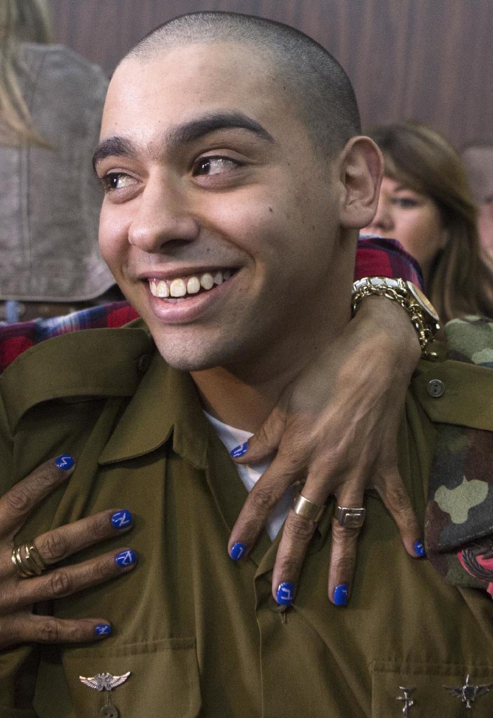 Israeli soldier Elor Azaria is embraced by his mother at the start of his sentencing hearing in Tel Aviv, Israel, Tuesday, Feb. 21, 2017. The court sentenced Azaria to 18 months in prison for the fatal shooting of a wounded Palestinian assailant. The Palestinian, Abdel Fattah al-Sharif, was lying on the ground badly wounded and already unarmed when Azaria shot him in the head. Prosecutors had asked that Sgt. Elor Azaria be sentenced to 3-5 years in prison. (Jim Hollander, Pool, via AP)