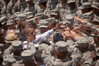 <p>President Barack Obama greets soldiers after signing an executive order requiring more disclosure by colleges at Fort Stewart army base on April 27, 2012 in Hinesville, Georgia. This is Obama’s first trip to Fort Stewart during which he is scheduled to meet with soldiers and their families. (Richard Ellis/Getty Images) </p>