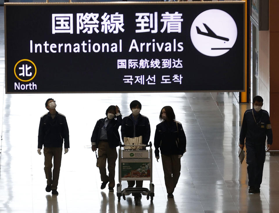 Passengers walk at the lobby for the international arrivals at Kansai International Airport in Osaka, western Japan, Tuesday, Nov. 30, 2021. Japan confirmed on Tuesday its first case of the new omicron coronavirus variant, a visitor who recently arrived from Namibia, an official said.(Yukie Nishizawa/Kyodo News via AP)