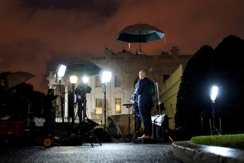 Journalists report before dawn at the White House after U.S. President Donald Trump announced that he and U.S. first lady Melania Trump have both tested positive for the coronavirus disease (COVID-19) in Washington, U.S., October 2, 2020.      REUTERS/Joshua Roberts     TPX IMAGES OF THE DAY
