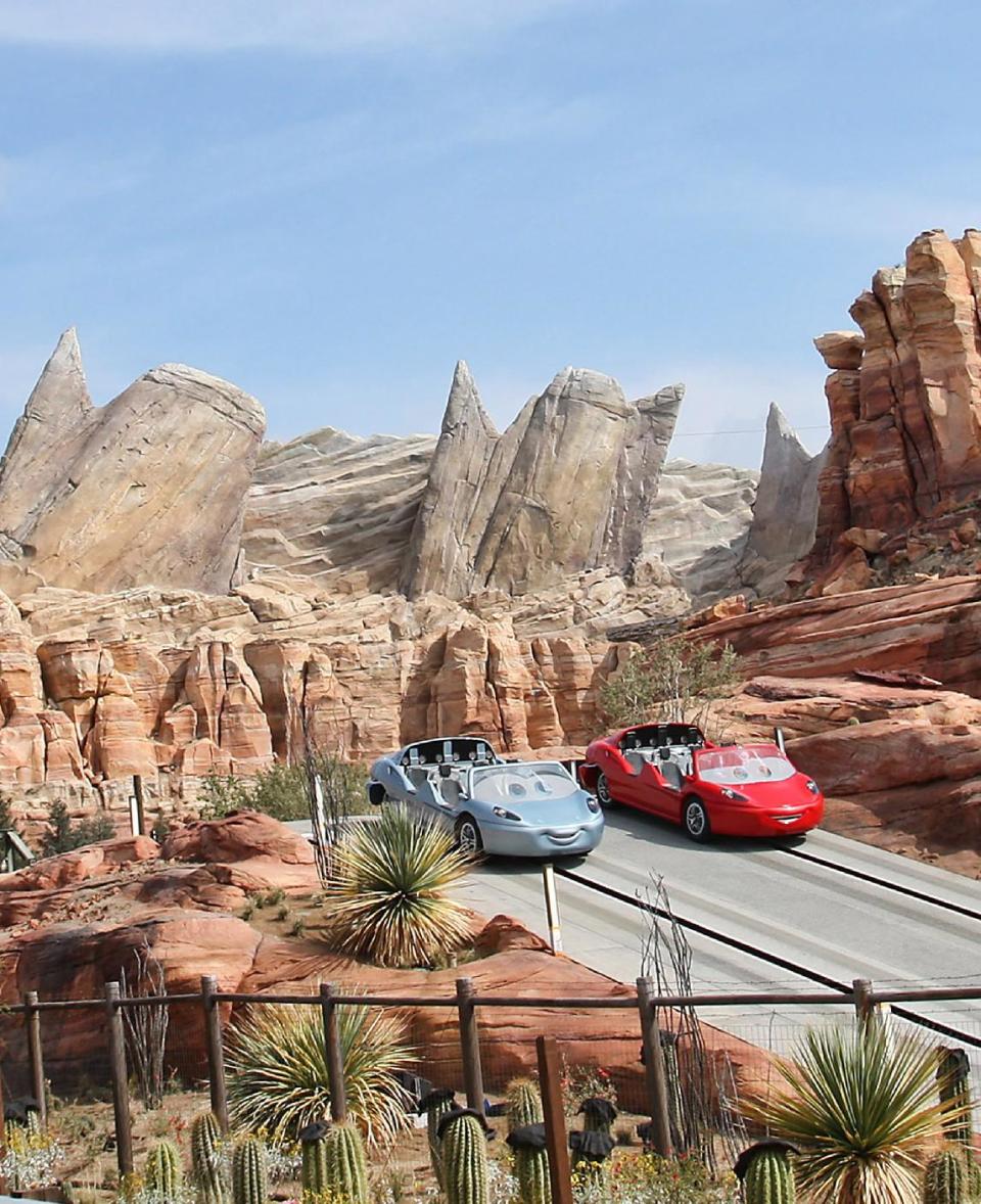 In this 2012 image released by Disney theme parks, Radiator Springs Racers are shown at Cars Land, a new attraction based on the Disney-Pixar animated series "Cars," at Disney California Adventure park in Anaheim, Calif. Cars Land features three family attractions showcasing characters and settings from the film. (AP Photo/Disney, Paul Hiffmeyer)