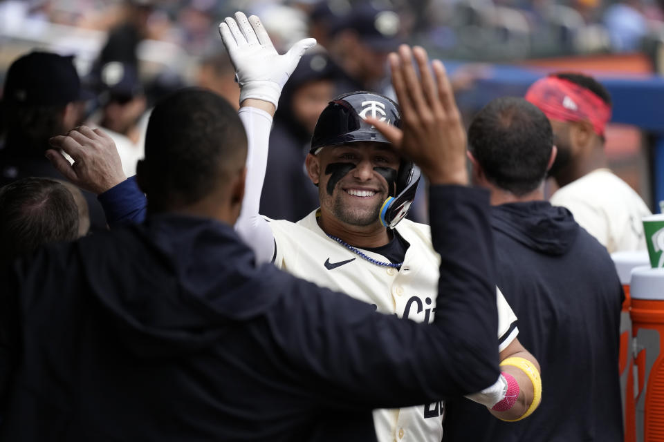 Minnesota Twins' Royce Lewis, back, center, celebrates in the dugout after hitting a two-run home run during the sixth inning of a baseball game against the Colorado Rockies, Wednesday, June 12, 2024, in Minneapolis. (AP Photo/Abbie Parr)