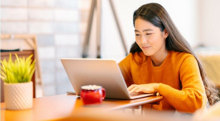 Asian woman checks her investments