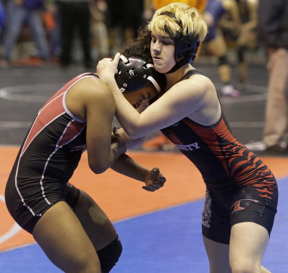 FILE - In this Friday, Feb. 24, 2017, file photo, Mack Beggs, right, a transgender wrestler from Euless Trinity, competes in a quarterfinal against Mya Engert of Amarillo Tascosa during the state wrestling tournament in Cypress, Texas. Beggs, who won a girls wrestling state title in Texas, says he would compete against boys if allowed and is taking lower doses of testosterone to try to be fair to his opponents. (Melissa Phillip/Houston Chronicle via AP, File)
