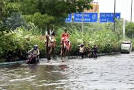 A couple of camels seen along the water logged Ring Road after an early morning heavy rain spell, on July 19, 2020 in New Delhi, India. Moderate-to-heavy rain lashed several states in northern, eastern and coastal India on Sunday, but the monsoon activity continued to remain subdued in Delhi, which has recorded a 40 per cent rainfall deficiency despite an early onset of the seasonal weather system. (Photo By Sonu Mehta/Hindustan Times via Getty Images)