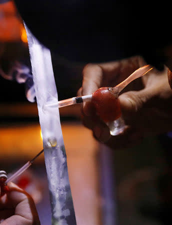 A drug user inhales "Shabu", or methamphetamine, at a drug den in Manila, Philippines February 13, 2017. REUTERS/Erik De Castro