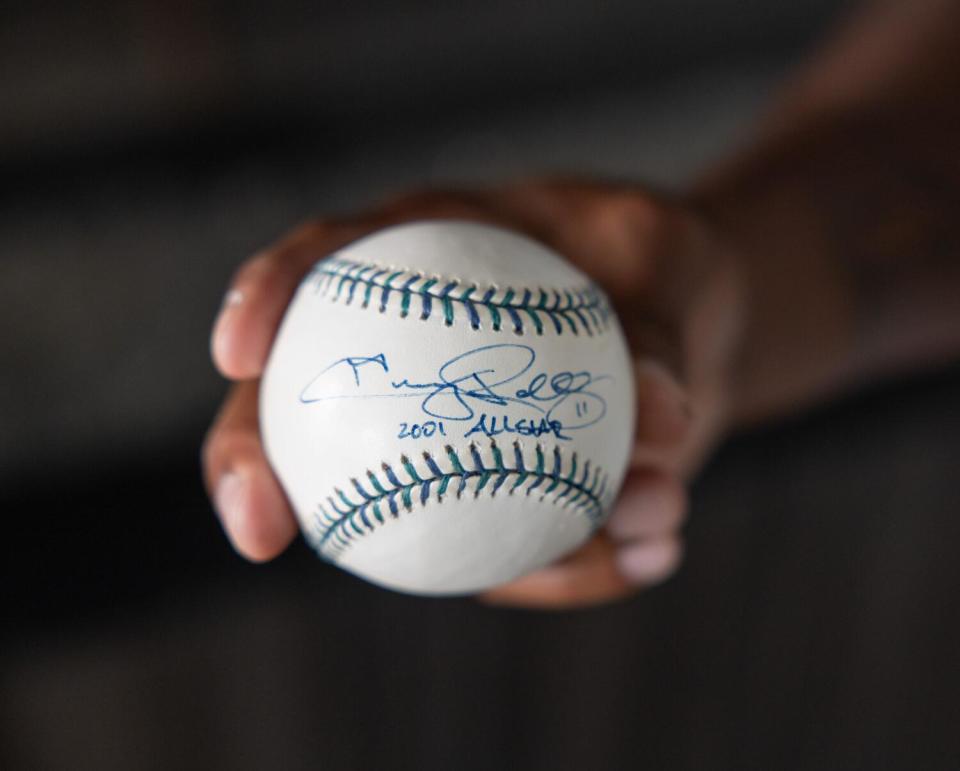 Jimmy Rollins shows off a baseball he had autographed during the 2001 MLB All-Star Game.