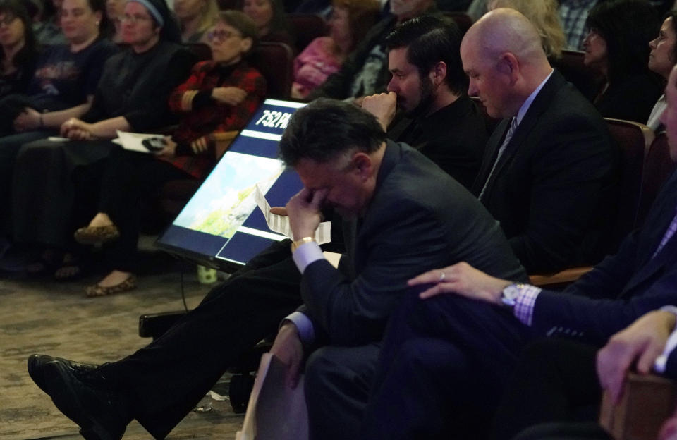 Frank DeAngelis, center, who was principal of Columbine High School during the massacre nearly 20 years earlier, fights back tears during a faith-based memorial service for the victims of the massacre, at a community church, Thursday, April 18, 2019, in Littleton, Colo. (Rick Wilking/Pool Photo via AP)