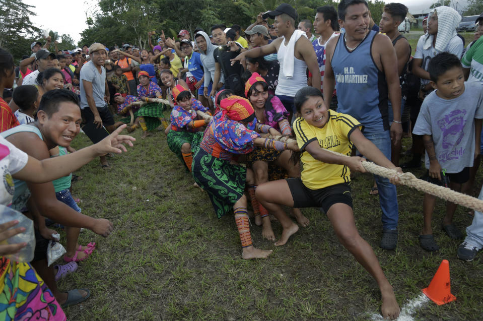 Guna women compete in the tug-of-war event during the second edition of their indigenous games, in Piriati, Panama, on Sunday, Nov. 25, 2018. Indigenous people from the four most important ethnic groups in Panama participated for two days of games to select the athletes who will represent Panama in the upcoming World Indigenous Peoples Games. (AP Photo/Arnulfo Franco)