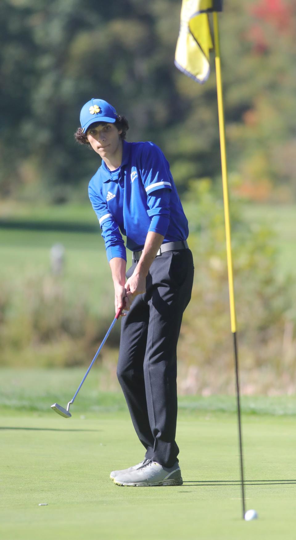 Coventry's Ryan Dinan watches his parr putt sink on the No. 17 green during the Boys Division II District Golf Tournament on Oct. 4, 2022, at Windmill Lakes Golf Course in Ravenna.