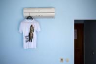A t-shirt with a picture of Russian President Vladimir Putin and the text "They can't catch us" is seen in this photo illustration taken in a hotel room in Kazan, Russia, July 30, 2015. REUTERS/Stefan Wermuth