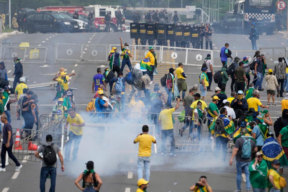 Protesters, supporters of former President Jair Bolsonaro, clash with police during a protest outside the Planalto Palace building in Brasilia, Brazil, on Sunday. Other demonstrators stormed congress and the Supreme Court.