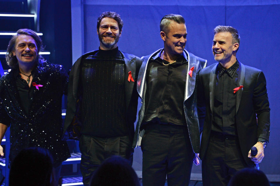 LONDON, ENGLAND - DECEMBER 04:  (L to R)   Mark Owen, Howard Donald, Robbie Williams and Gary Barlow of Take That perform at the Opening Night Gala of "The Band" to benefit the Elton John AIDS Foundation supported by The Evening Standard at Theatre Royal Haymarket on December 4, 2018 in London, England.  (Photo by David M. Benett/Dave Benett/Getty Images) 