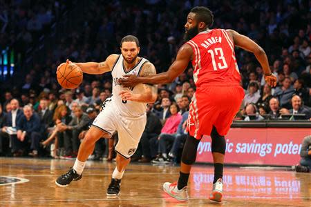 Apr 1, 2014; Brooklyn, NY, USA; Brooklyn Nets guard Deron Williams (8) dribbles the ball past Houston Rockets guard James Harden (13) during the third quarter at Barclays Center. The Nets defeated the Rockets 105-96. Mandatory Credit: Ed Mulholland-USA TODAY Sports