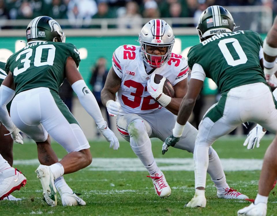 Ohio State running back TreVeyon Henderson carries the ball against Michigan State.