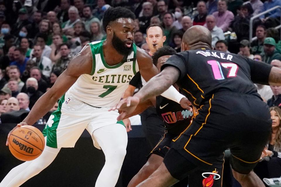 Boston Celtics guard Jaylen Brown (7) drives to the basket against Miami Heat forward P.J. Tucker (17) during the first half of an NBA basketball game Wednesday, March 30, 2022, in Boston. (AP Photo/Charles Krupa)