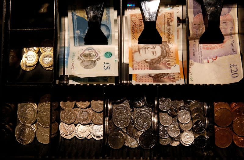 FILE PHOTO: Pound Sterling notes and change are seen inside a cash resgister in a coffee shop in Manchester