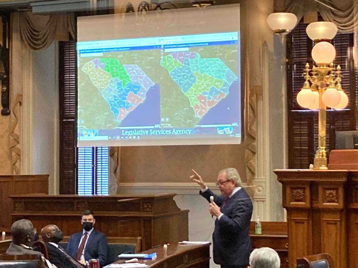 State Sen. Dick Harpootlian, D-Columbia, compares his proposed map of U.S. House districts drawn with 2020 U.S. Census data to a plan supported by Republicans on Thursday, Jan. 20, 2022, in Columbia, S.C.. The full Senate was debating the maps. (AP Photo/Jeffrey Collins)