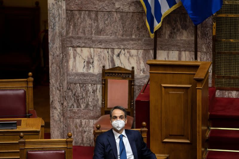 Greek PM Mitsotakis wears a protective face mask during a parliamentary session on revelations of abuse in arts and sports, in Athens