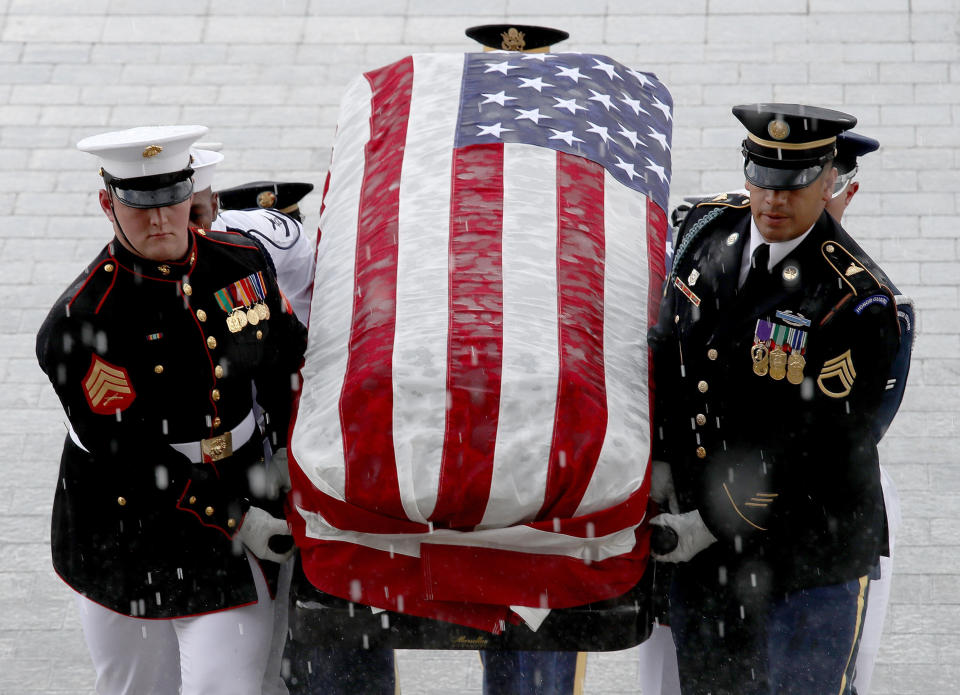 A military honor guard team carries the casket of the late senator into the Capitol. (Photo: Win McNamee/Getty Images)