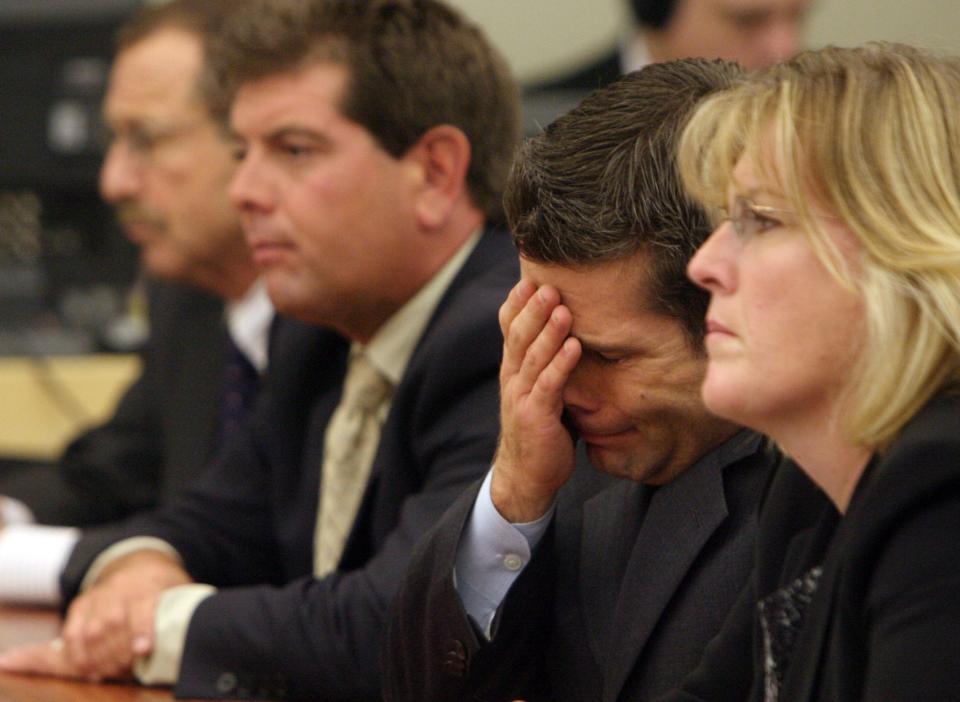 Michael, left center, and Jeffrey Derderian, flanked by their lawyers Richard Egbert, left and Kathleen Hagerty listen to victim impact statements during their plea hearing at Kent County Court.