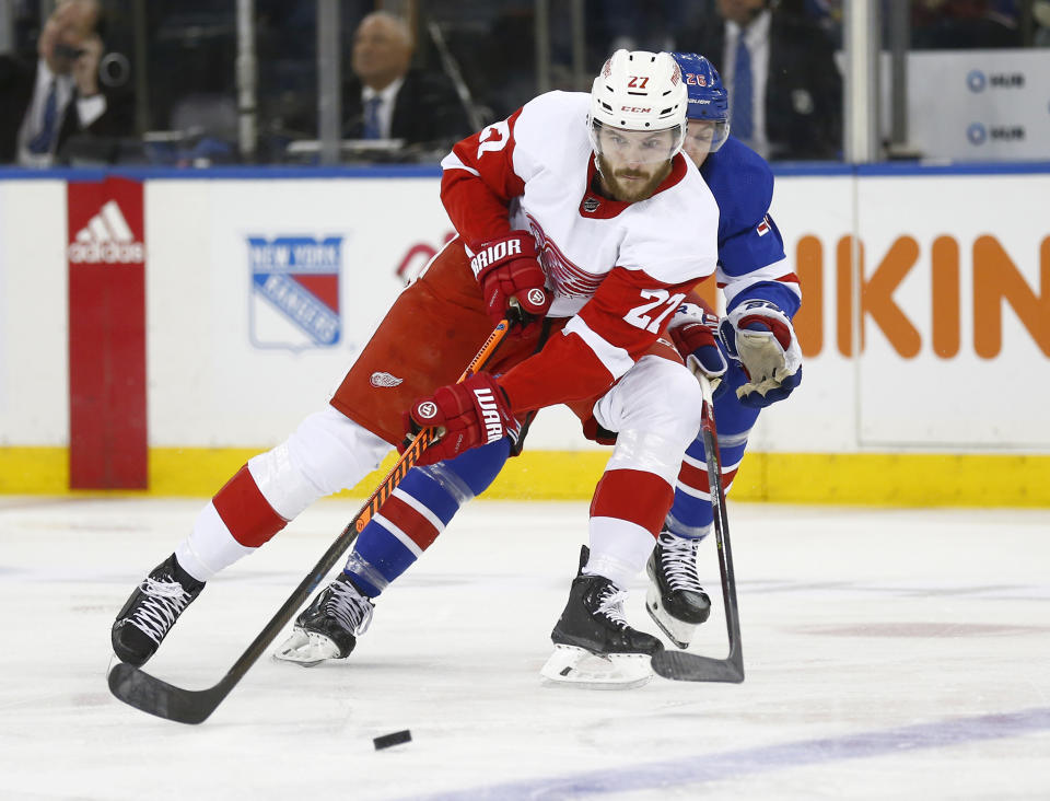 Detroit Red Wings center Michael Rasmussen (27) shields the puck from New York Rangers left wing Jimmy Vesey during the first period of an NHL hockey game Sunday, Nov. 6, 2022, in New York. (AP Photo/John Munson)