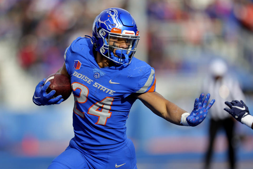 FILE - Boise State running back George Holani (24) runs with the ball against Utah State in the second half of an NCAA college football game, Friday, Nov. 25, 2022, in Boise, Idaho. Boise State has gone three seasons without hoisting the MW trophy and will look to rectify that behind a rushing attack led by Holani, who had 1,157 yards and 10 touchdowns, and Ashton Jeanty, who ran for 821 yards and seven scores. (AP Photo/Steve Conner, File)