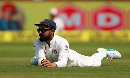 Cricket - India v England - Second Test cricket match - Dr. Y.S. Rajasekhara Reddy ACA-VDCA Cricket Stadium, Visakhapatnam, India - 19/11/16. India's captain Virat Kohli reacts as he lies on the ground. REUTERS/Danish Siddiqui