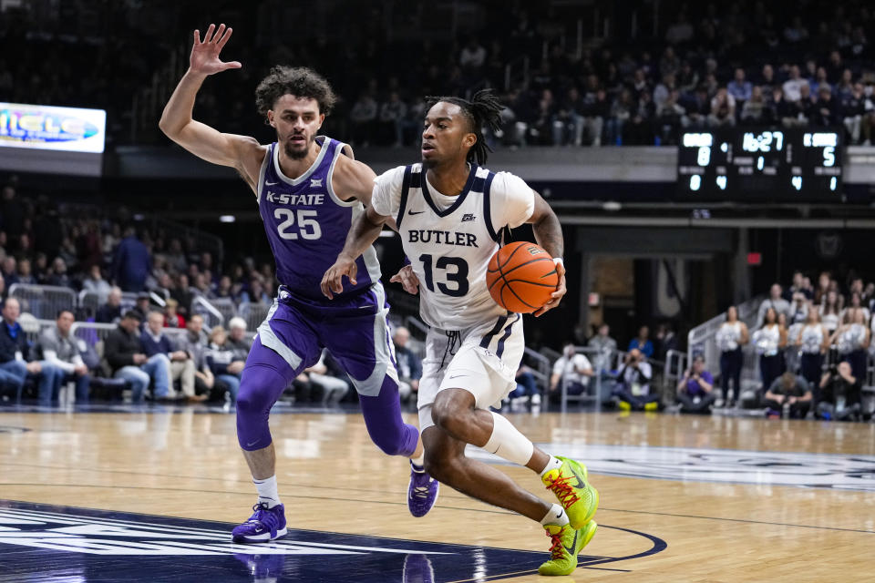 Butler guard Jayden Taylor (13) drives on Kansas State forward Ismael Massoud (25) in the first half of an NCAA college basketball game in Indianapolis, Wednesday, Nov. 30, 2022. (AP Photo/Michael Conroy)