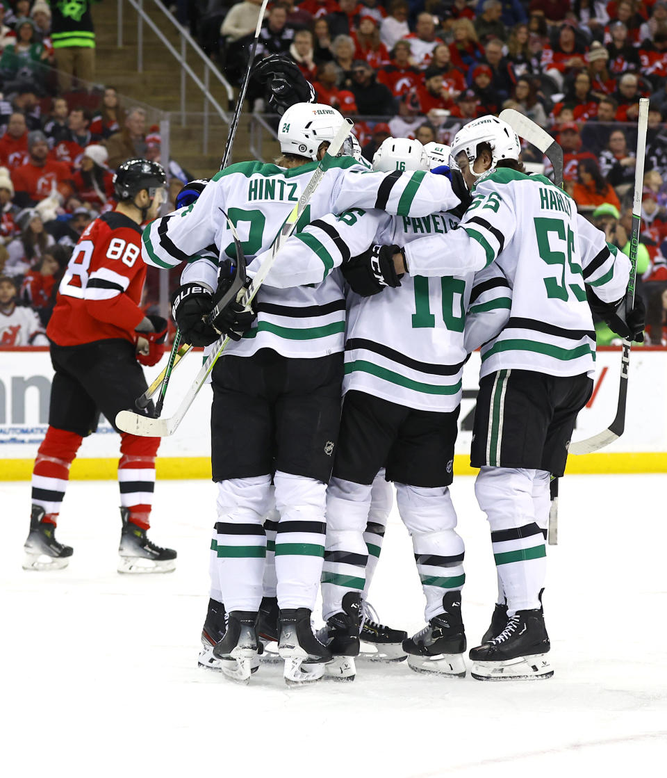 The Dallas Stars celebrate after scoring a goal against the New Jersey Devils during the first period of an NHL hockey game Saturday, Jan. 20, 2024, in Newark, N.J. (AP Photo/Noah K. Murray)