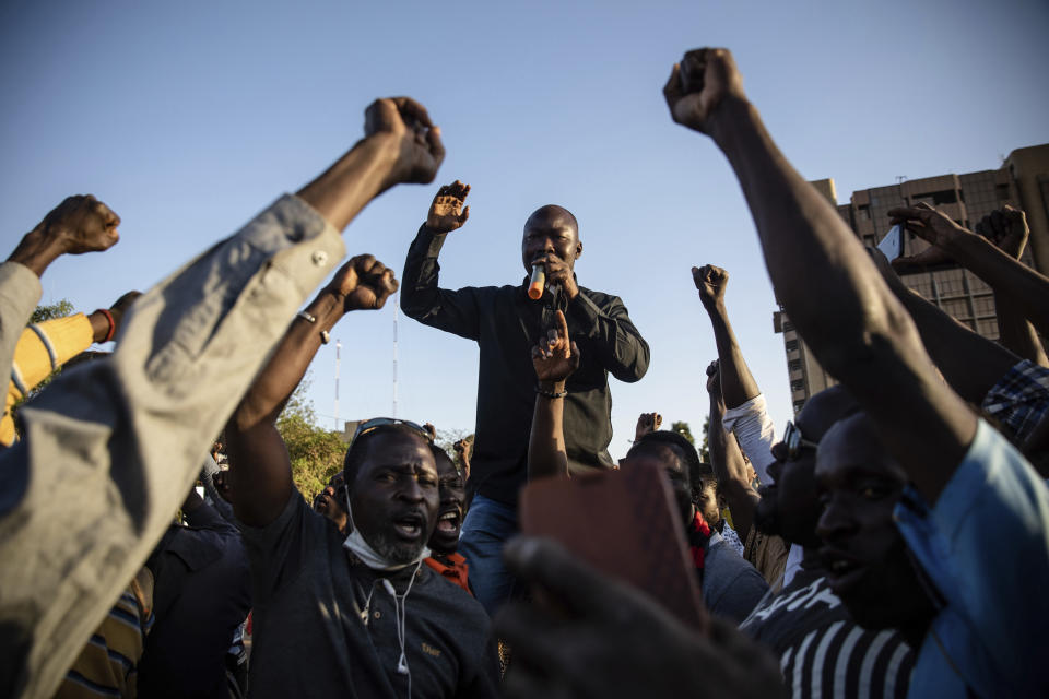 FILE - Activist Mamadou Drabo, leader of the Save Burkina Faso movement, announces to the crowd gathered Place de la Nation that Lt. Col. Paul Henri Sandaogo Damiba has taken the reins of the country in Ouagadougou, Burkina Faso, Monday, Jan. 24, 2022. Not everyone is hostile to last week's coup in Niger. Neighboring Burkina Faso and Mali have taken the unusual step of declaring that foreign military intervention in Niger would be a declaration of war against them, too. Both have had coups in recent years. (AP Photo/Sophie Garcia, File)