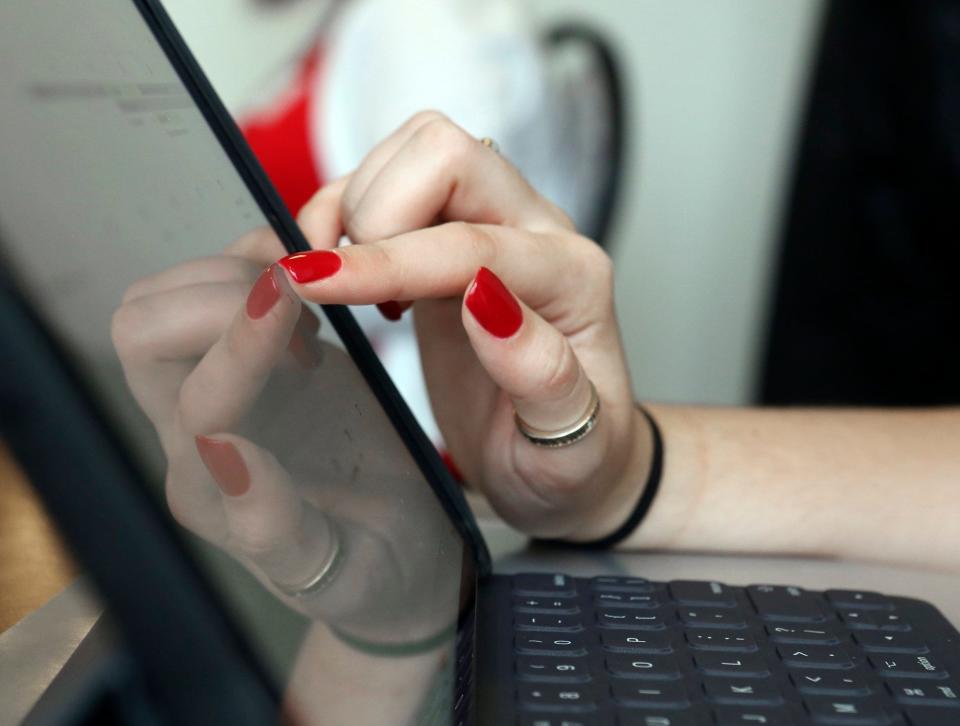 Melanie Funkhouser, of Dallas, painted her nails scarlet for orientation tests out her new iPad at the Drake Performance & Event Center at OSU June 12, 2018. OSU announced Tuesday it will stop distributing iPads to incoming freshmen this fall.