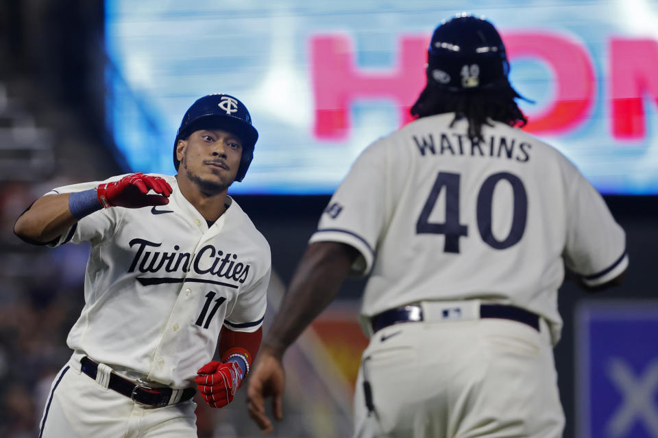 Minnesota Twins' Jorge Polanco, left, runs the bases on his three-run home run against the Cleveland Guardians in the fourth inning of a baseball game Monday, Aug. 28, 2023, in Minneapolis. (AP Photo/Bruce Kluckhohn)