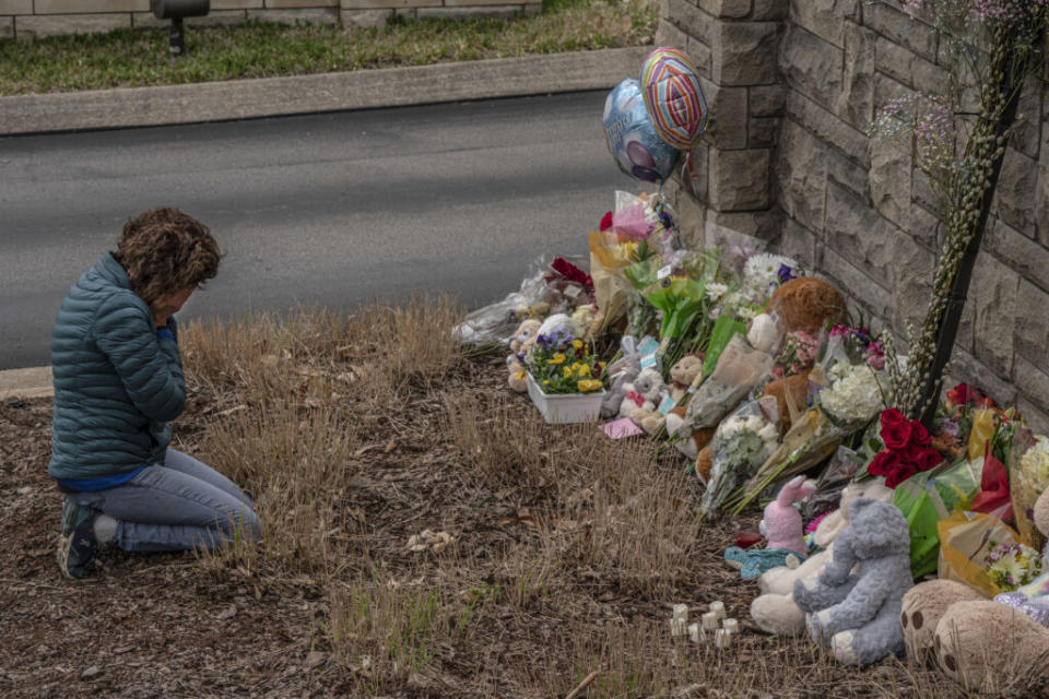 A day after a mass shooting at The Covenant School, a woman is overcome with emotion in front of an impromptu memorial. (Photo: John Partipilo)